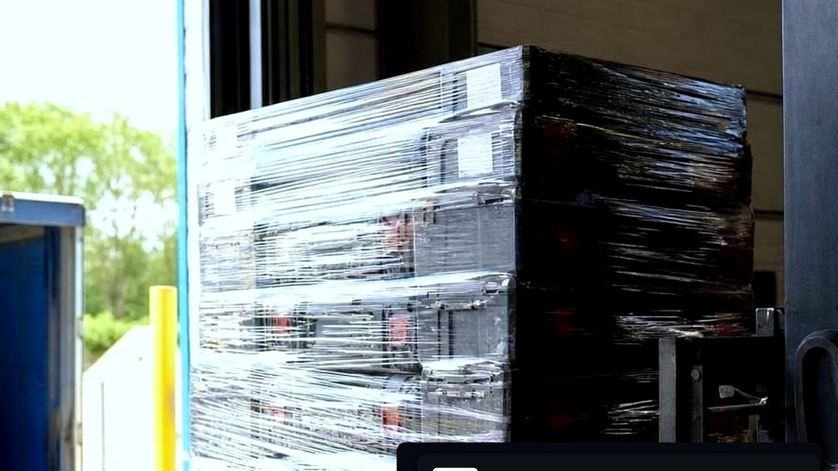 Wrapped wholesale tools pallet with power tools on wood in a warehouse